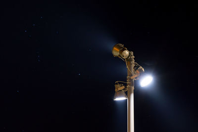 Close-up of illuminated lamp against black background
