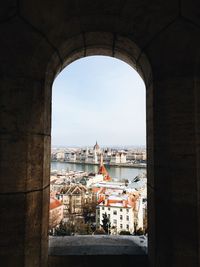 Cityscape seen through arched window
