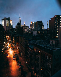 Illuminated cityscape against sky at night