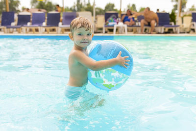 Portrait of boy swimming in pool