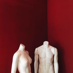 Close-up of mannequin against red wall
