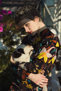 Close up pretty woman holding puppy in home garden portrait picture