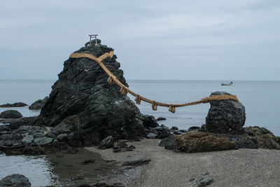 Rope tied on rocks on beach