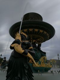 Low angle view of statue against sky