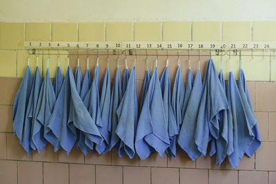 Close-up of clothes drying against white wall