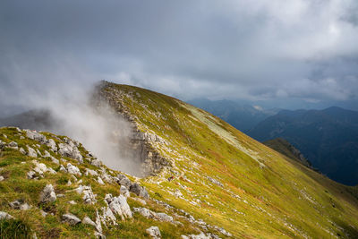 Scenic view of green mountains against sky