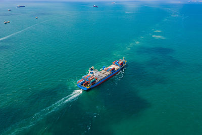 High angle view of shipping container sailing in sea