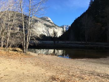 Scenic view of lake by mountain against sky
