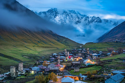 High angle view of townscape by mountain against sky