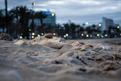 Surface level of beach against sky in city