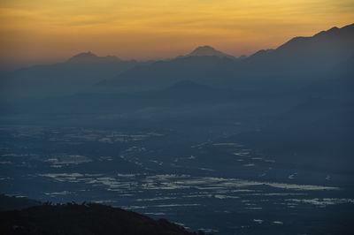 Scenic view of silhouette mountains against sky during sunset