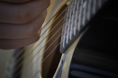 Cropped hand of person playing guitar