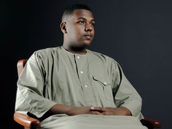 Young man sitting on table