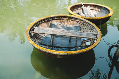 Close-up of boat moored in lake