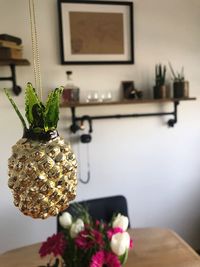 Close-up of flower vase on table at home