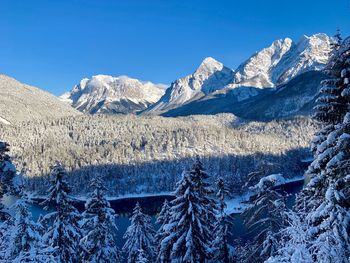 Scenic view of snowcapped mountains against clear blue sky