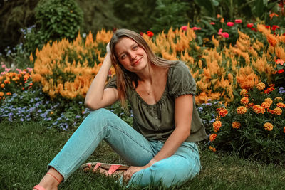 Young woman sitting on field