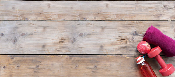 High angle view of red berries on wooden table