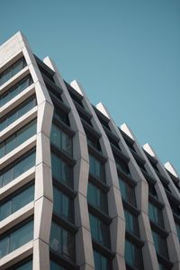 Low angle view of office building against clear sky