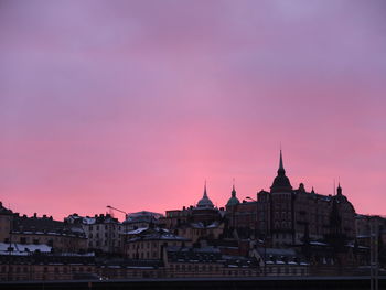 Buildings in city at sunset