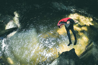 High angle view woman jumping in water