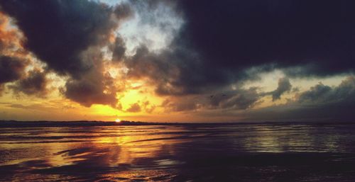 Scenic view of sea against cloudy sky