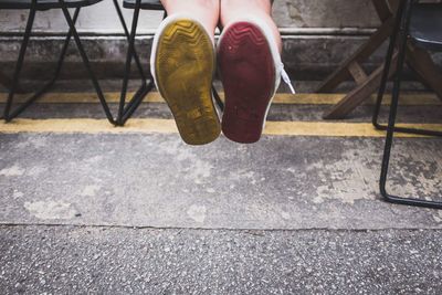 Low section of woman wearing high heels on footpath