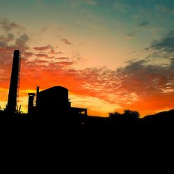 Low angle view of silhouette buildings against sky during sunset