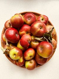 Heaped apples in circular dish. red and green apples. foraged in community orchard. fresh and juicy.