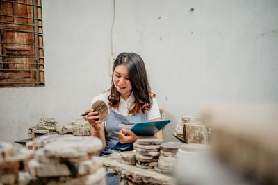 Portrait of young woman preparing food at home