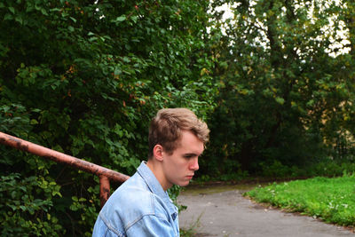 Side view of young man at park