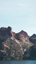 Rock formations by sea against sky