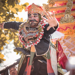 Portrait of man holding traditional clothing