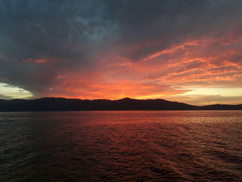 Scenic view of sea against romantic sky at sunset