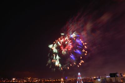 Low angle view of firework display at night