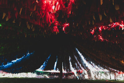 Panoramic shot of illuminated lights hanging at night