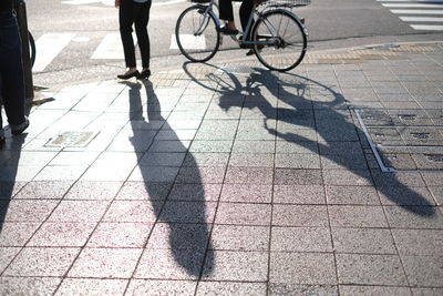 Low section of person riding bicycle on street