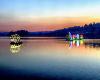 Scenic view of lake against sky during sunset
