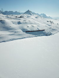 Snow covered landscape against sky