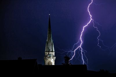 Low angle view of lightning against sky at night