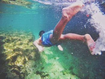 High angle view of boy swimming in sea