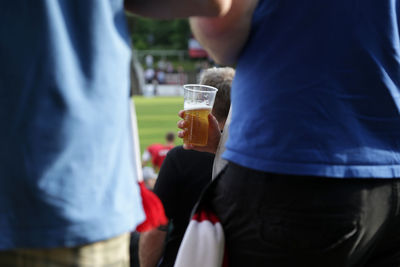 Cropped hand of person holding beer