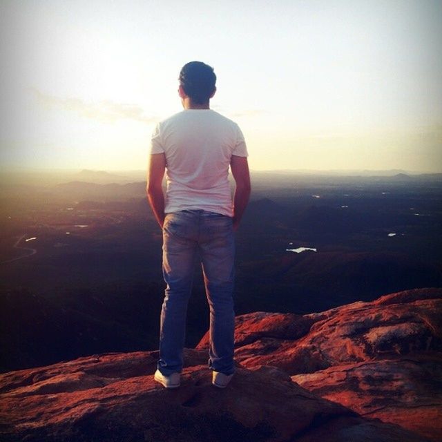 rear view, standing, tranquil scene, tranquility, scenics, full length, beauty in nature, lifestyles, leisure activity, casual clothing, nature, sea, looking at view, mountain, men, sky, idyllic, getting away from it all