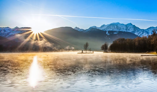 Scenic view of calm lake against mountain range