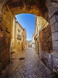 Narrow alley amidst buildings in city