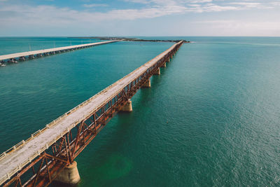 Pier over sea against sky