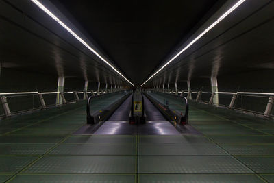 Illuminated subway station platform at night