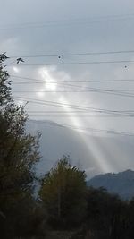 Low angle view of power lines against sky