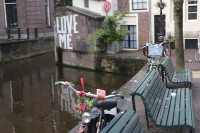 Parked bicycle and bench by canal