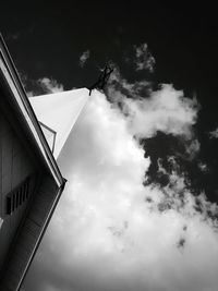 Low angle view of building against cloudy sky